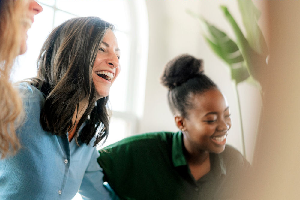 Group of women laughing while attending cannabis addiction support group